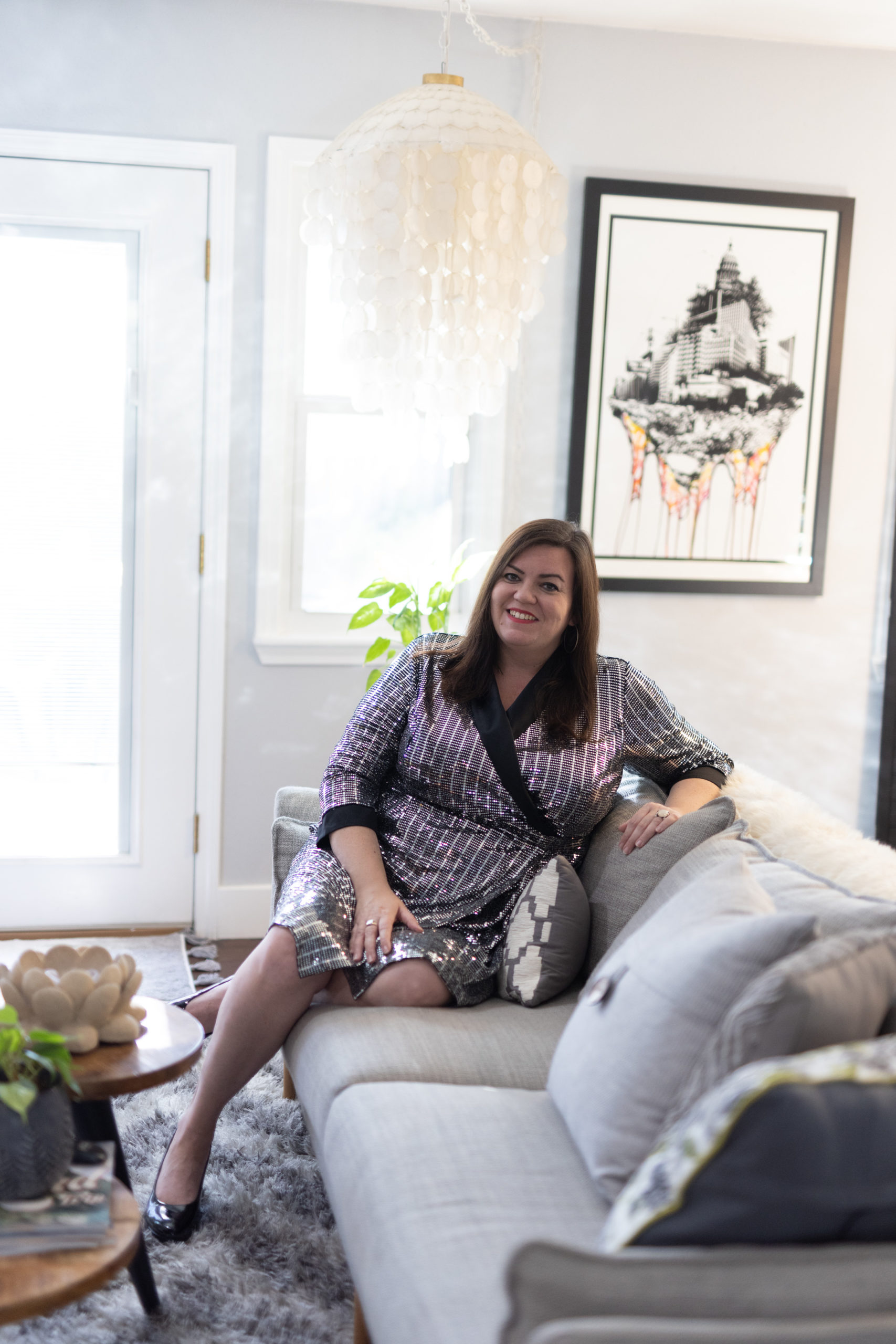 Anne Ahola Ward in a dress sitting on a couch